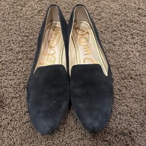 Black suede loafers with gold stitching